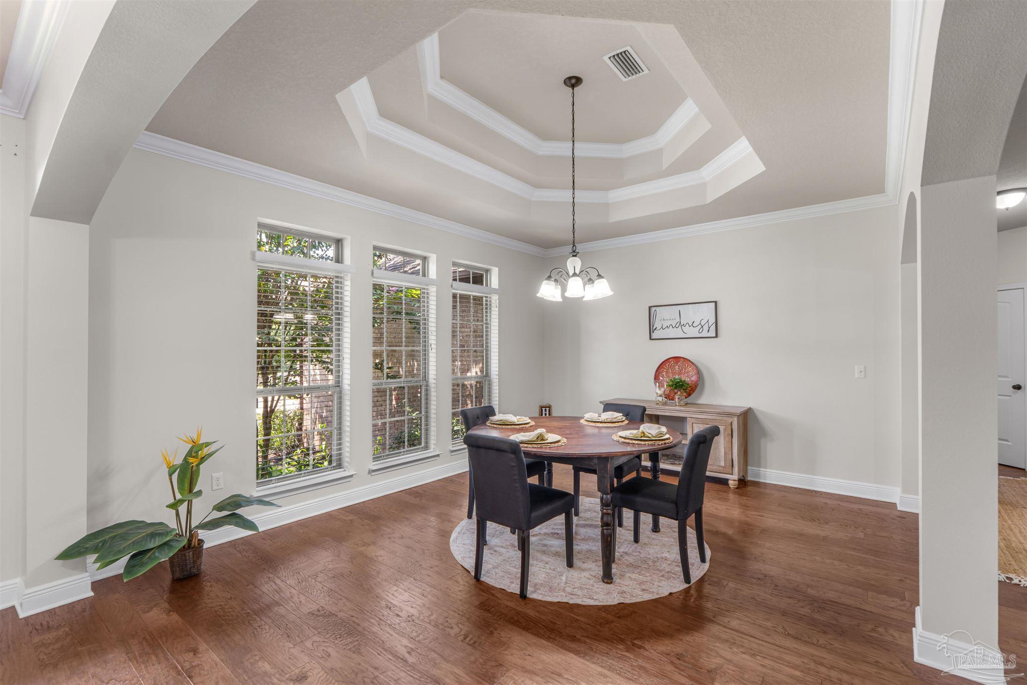 2698 Tulip Hill Road Pace, FL 32571 - Photo 11 of 65 a view of a dining room with furniture window and wooden floor