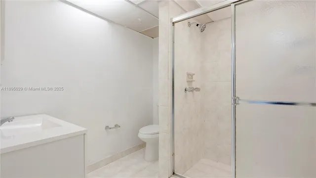 a bathroom with a shower toilet and sink