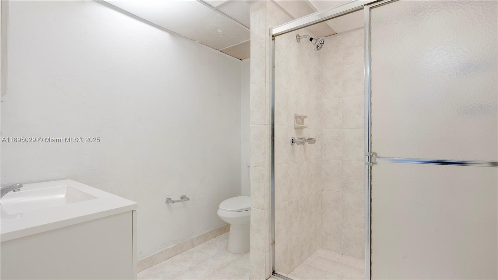 10000 Northwest 80th Court, Unit 2214 Hialeah Gardens, FL 33016 - Photo 12 of 21 a bathroom with a shower toilet and sink