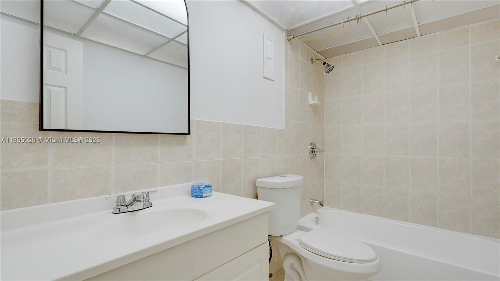 10000 Northwest 80th Court, Unit 2214 Hialeah Gardens, FL 33016 - Photo 16 of 21 a bathroom with a sink a toilet and a mirror