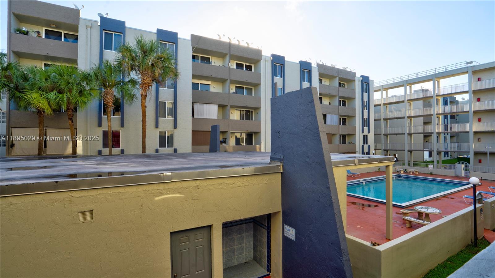 10000 Northwest 80th Court, Unit 2214 Hialeah Gardens, FL 33016 - Photo 20 of 21 a view of building with front door