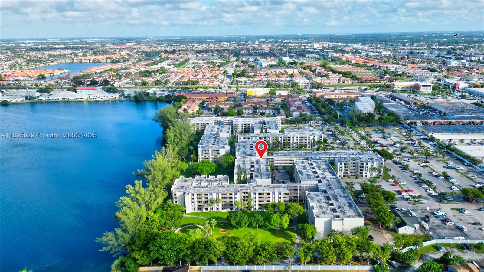 10000 Northwest 80th Court, Unit 2214 Hialeah Gardens, FL 33016 - Photo 2 of 21 an aerial view of a city with lots of residential buildings ocean and mountain view in back
