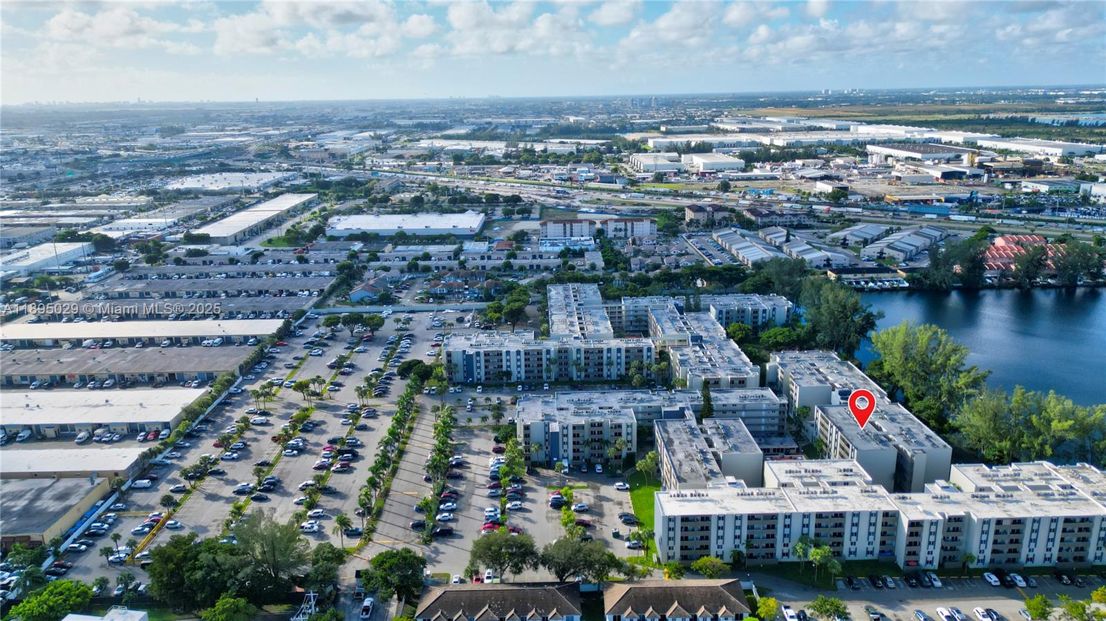 10000 Northwest 80th Court, Unit 2214 Hialeah Gardens, FL 33016 - Photo 4 of 21 an aerial view of residential building and lake