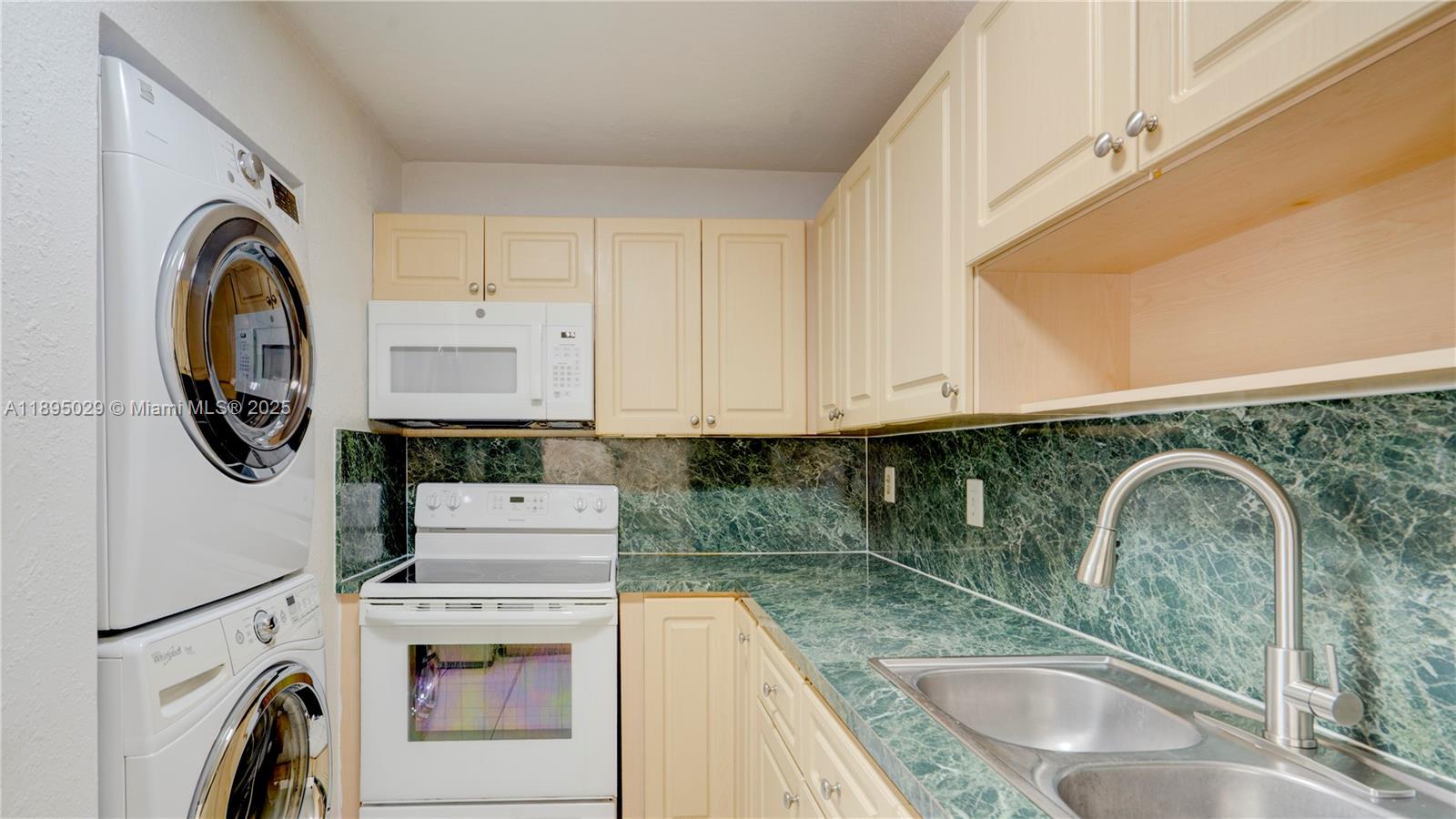 10000 Northwest 80th Court, Unit 2214 Hialeah Gardens, FL 33016 - Photo 7 of 21 a kitchen with sink a washer and dryer