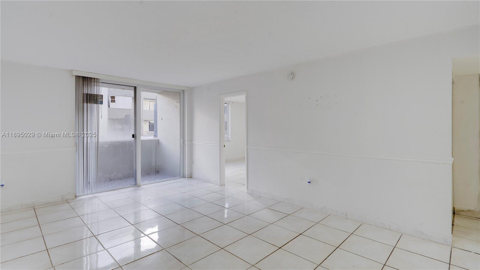 10000 Northwest 80th Court, Unit 2214 Hialeah Gardens, FL 33016 - Photo 9 of 21 a view of an empty room and window