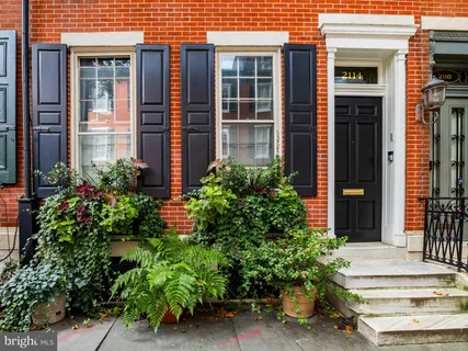 a view of a brick house with potted plants