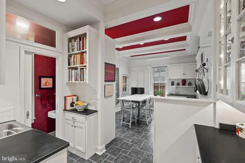 a kitchen with stainless steel appliances kitchen island granite countertop a sink and cabinets
