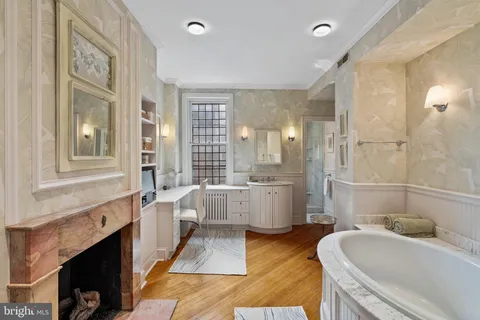 a spacious bathroom with a granite countertop tub sink a mirror a shower and vanity