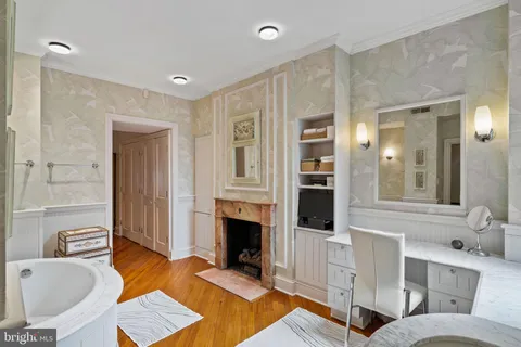 a spacious bathroom with a tub sink and mirror