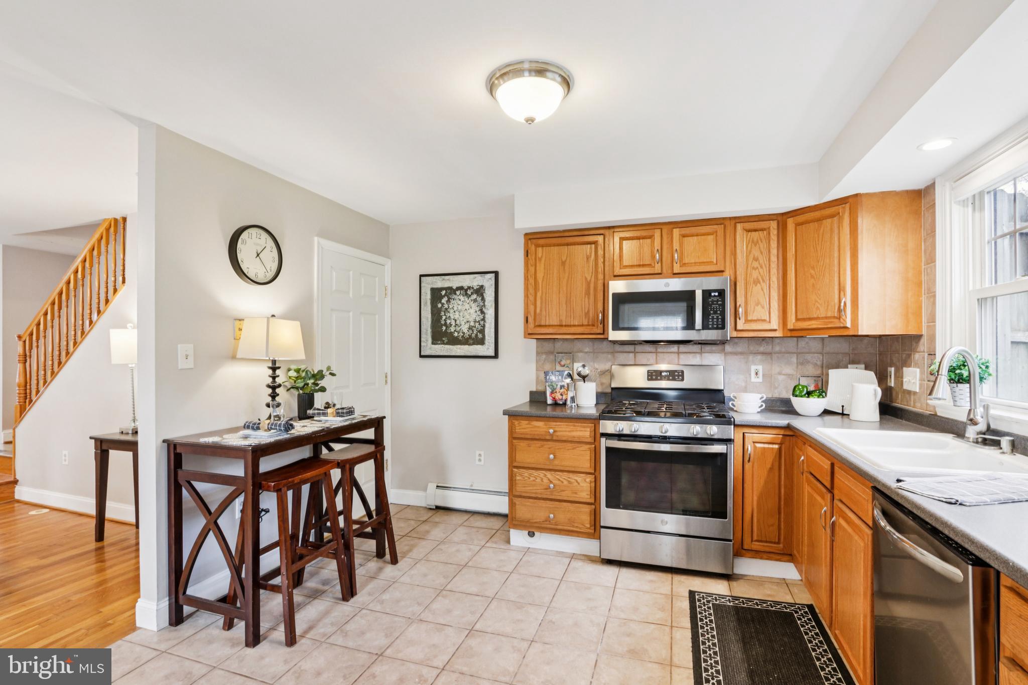 205 North Aberdeen Avenue Wayne, PA 19087 - Photo 12 of 46 a kitchen with stainless steel appliances granite countertop a stove top oven a sink a dining table and chairs