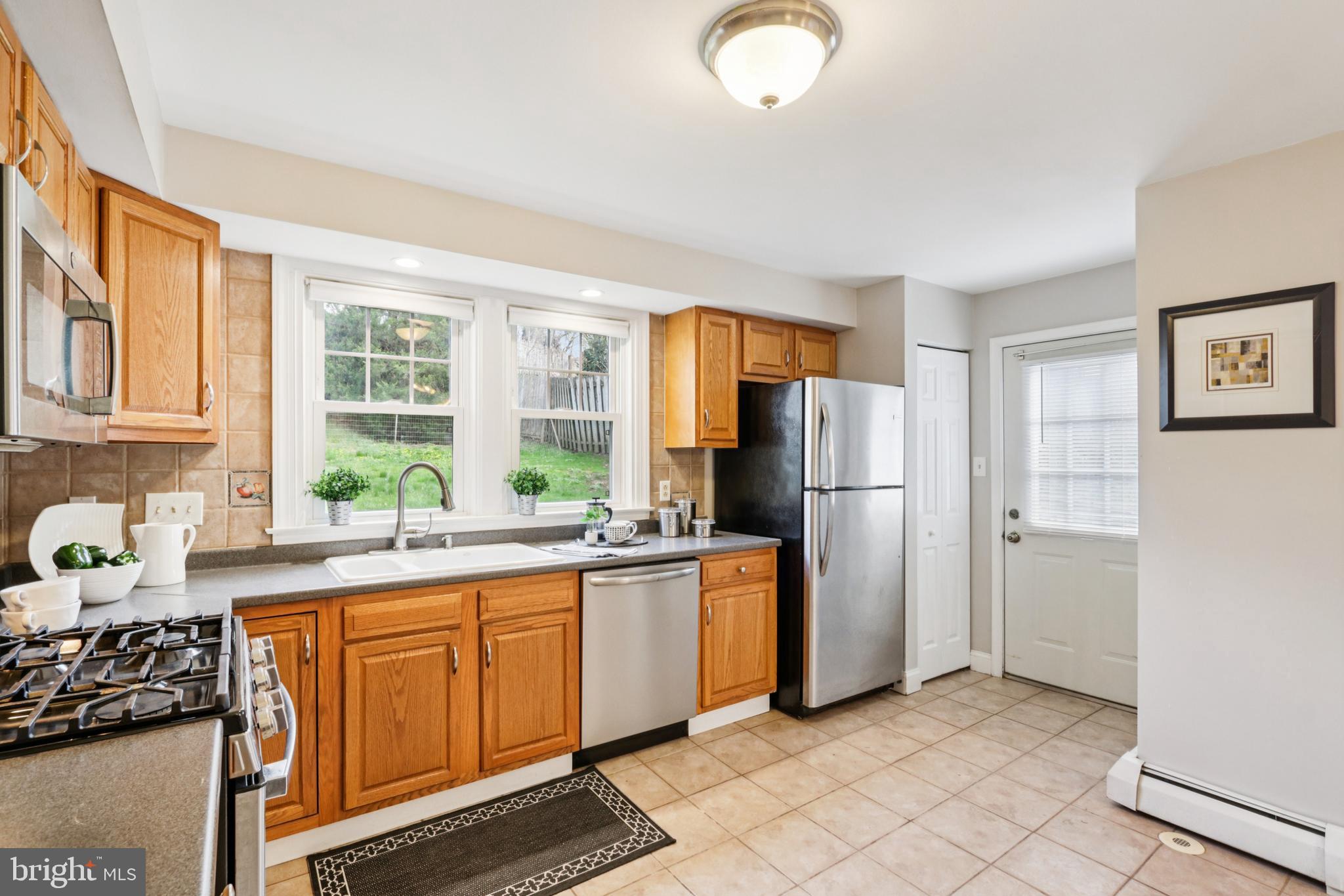 205 North Aberdeen Avenue Wayne, PA 19087 - Photo 14 of 46 a kitchen with stainless steel appliances granite countertop a refrigerator and a stove top oven
