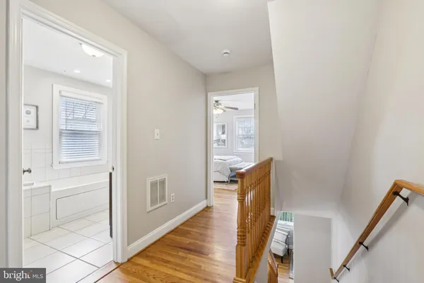 a bathroom with a bathtub sink and mirror with shower