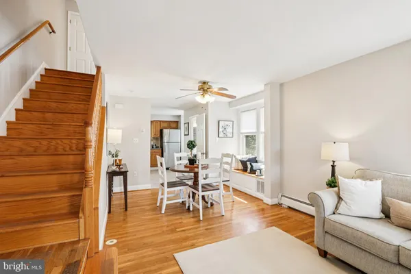 a view of a dining room with furniture and wooden floor