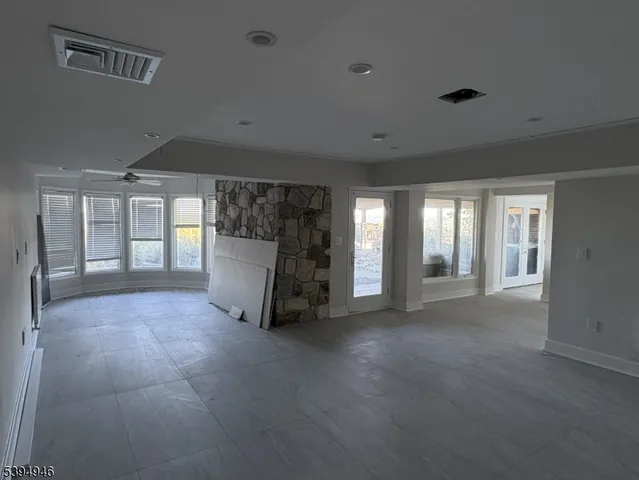 a view of a big room with closet and windows