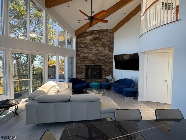 a living room with furniture a large window and a fireplace