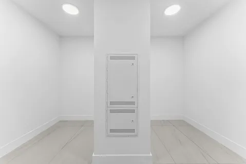a bathroom with a toilet a sink a tub and a mirror