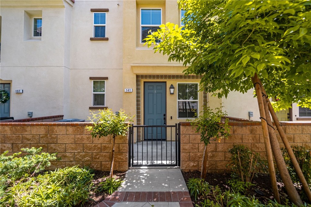 141 Macintosh Way Upland, CA 91786 - Photo 1 of 1 a front view of a house with a garden