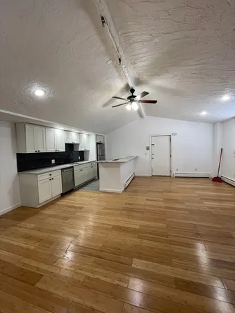 a large room with kitchen view and appliances