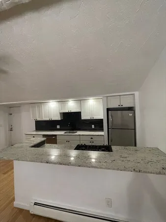a kitchen with stainless steel appliances granite countertop a refrigerator and a granite counter tops