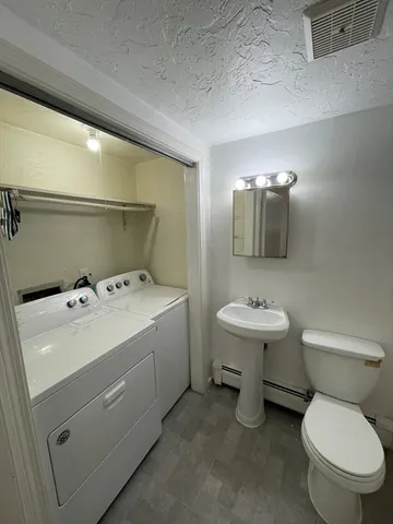 a bathroom with a sink toilet and mirror