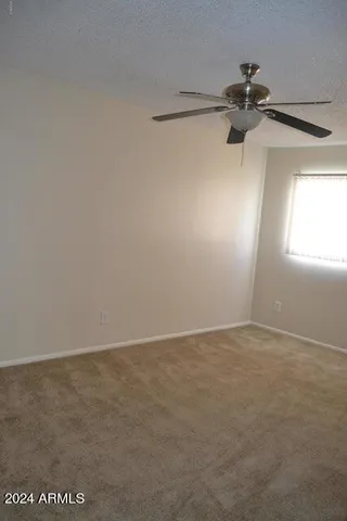 a bathroom with a granite countertop toilet and a shower