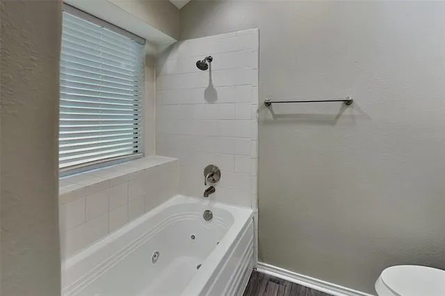 a bathroom with a bathtub and a toilet