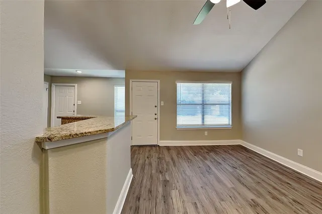 a view of a kitchen with a sink and wooden floor