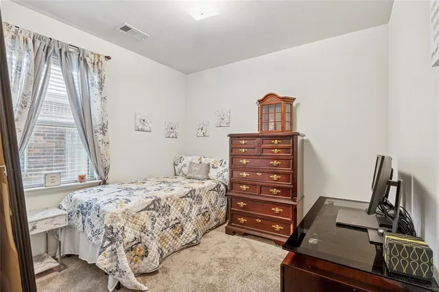 a bedroom with a bed and a flat tv screen