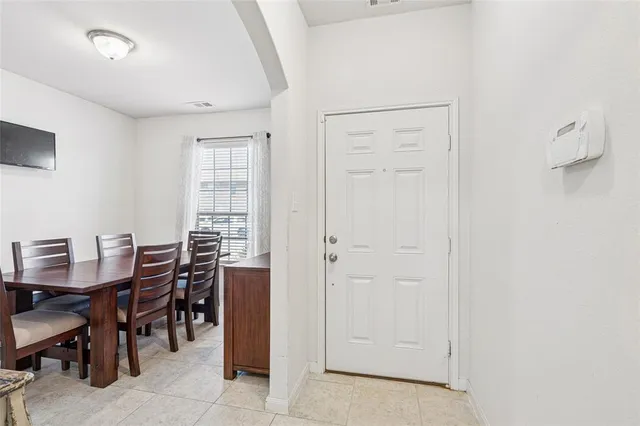 a view of a dining room with furniture and window