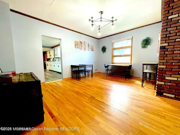 a kitchen with stainless steel appliances cabinets a dining table and chairs