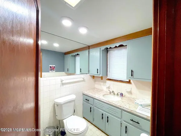 a bathroom with a tub sink and mirror