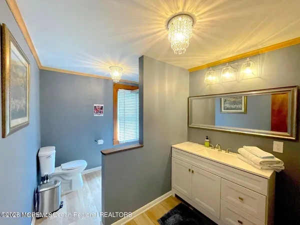 a room with a bed and a mirror on the dresser