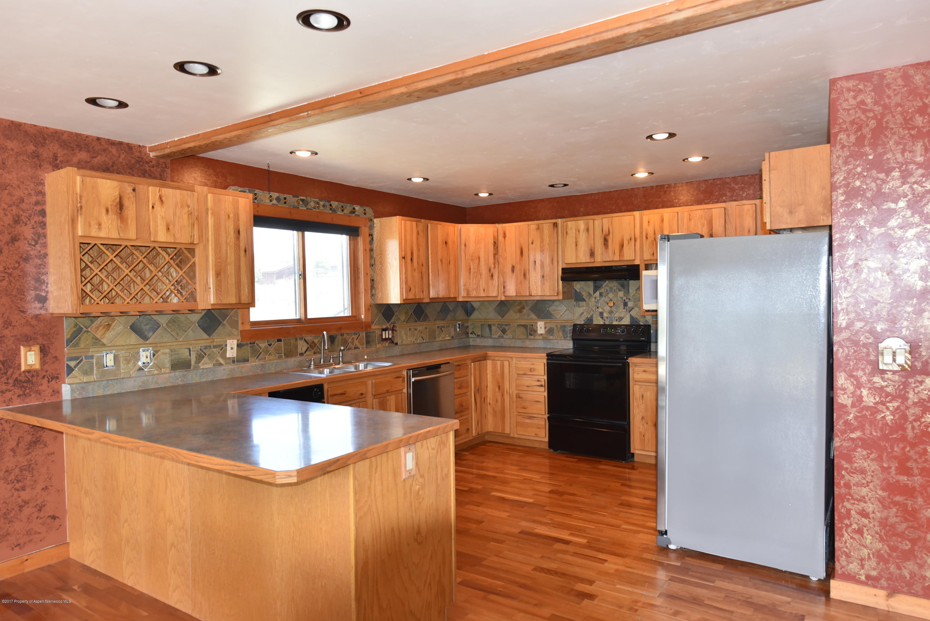 3744 County Road 237 Rifle, CO 81650 - Photo 12 of 37 a kitchen with a refrigerator a sink and cabinets