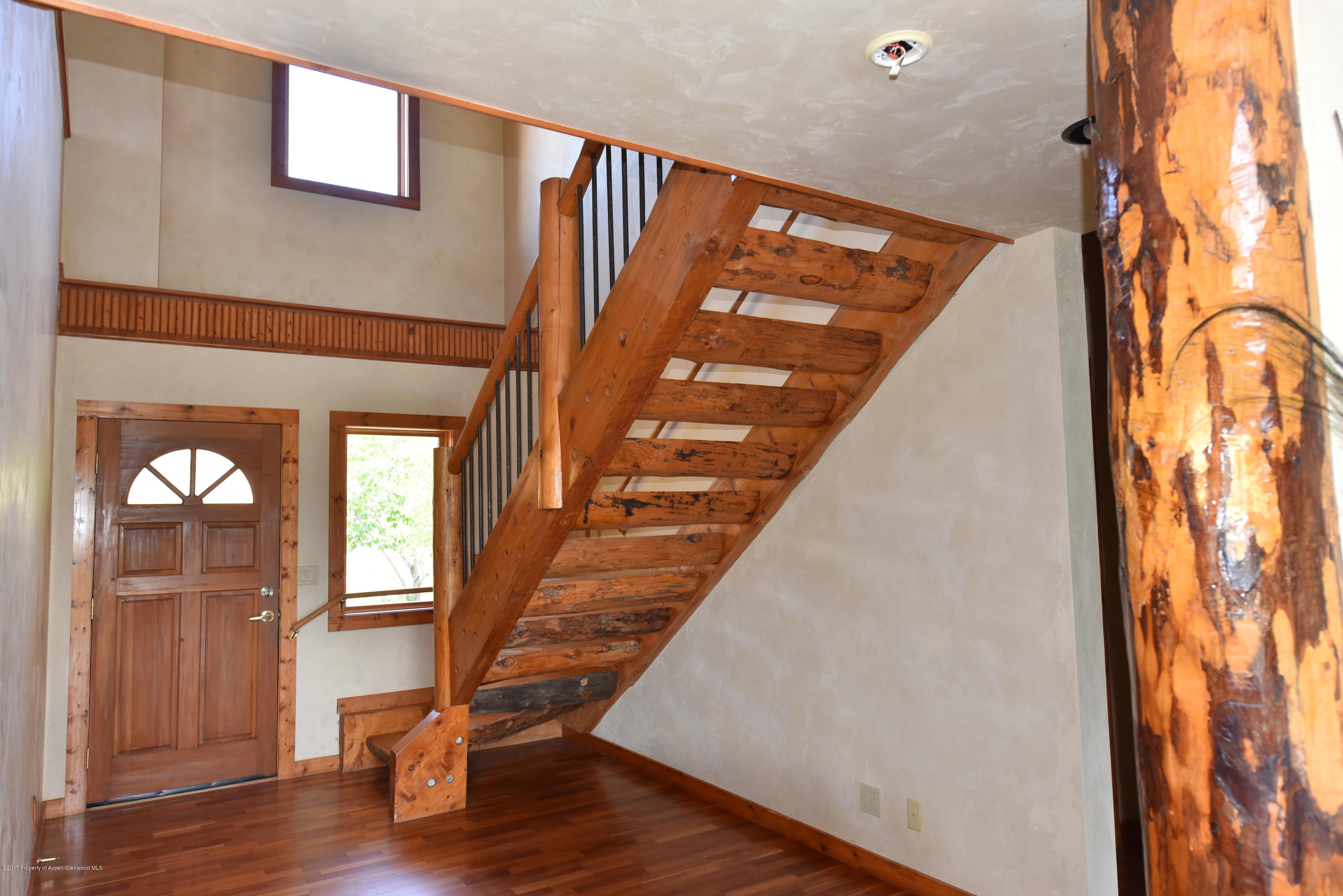 3744 County Road 237 Rifle, CO 81650 - Photo 13 of 37 a view of staircase with wooden floor and chair