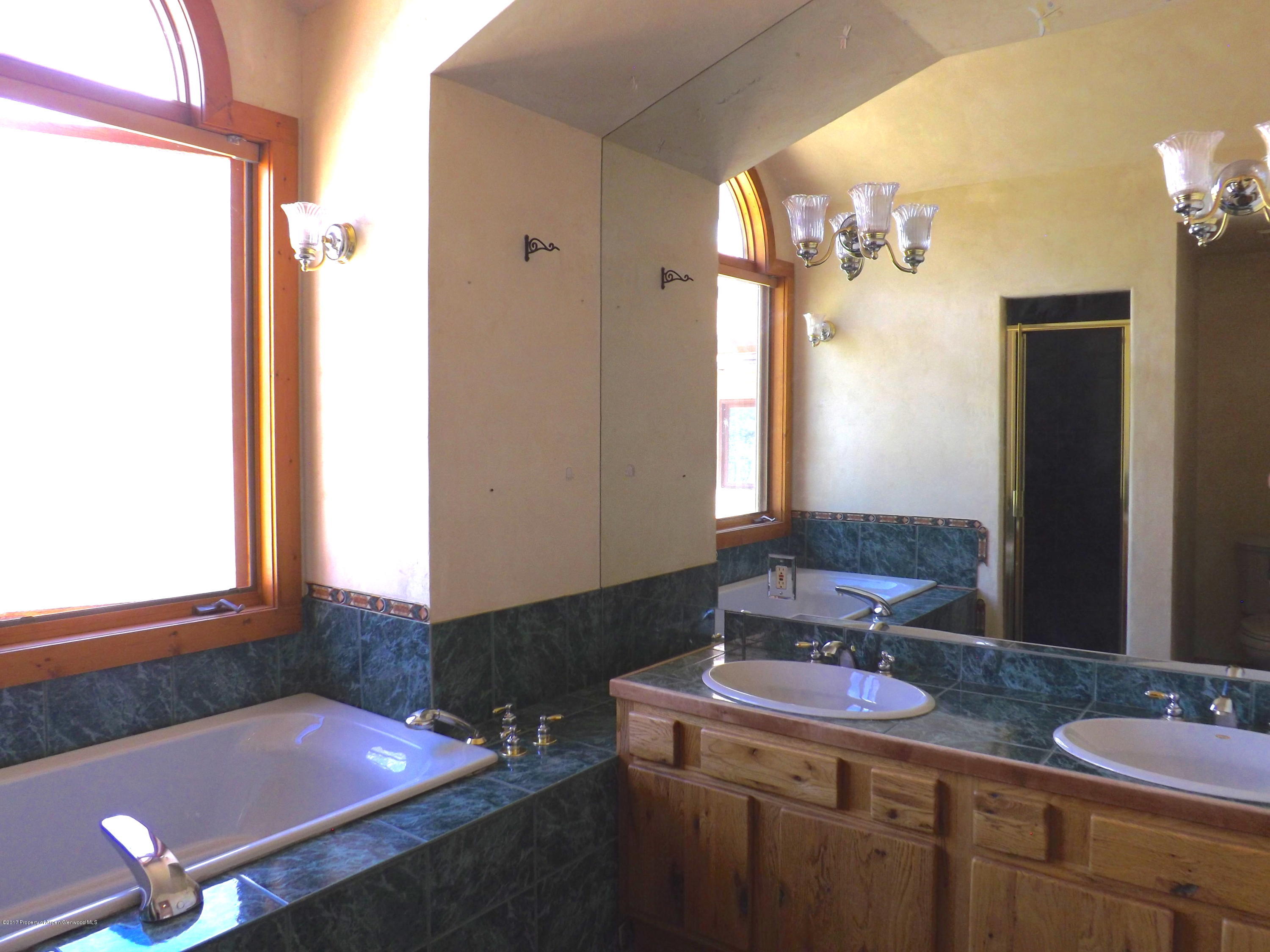 3744 County Road 237 Rifle, CO 81650 - Photo 15 of 37 a bathroom with a sink vanity and a mirror