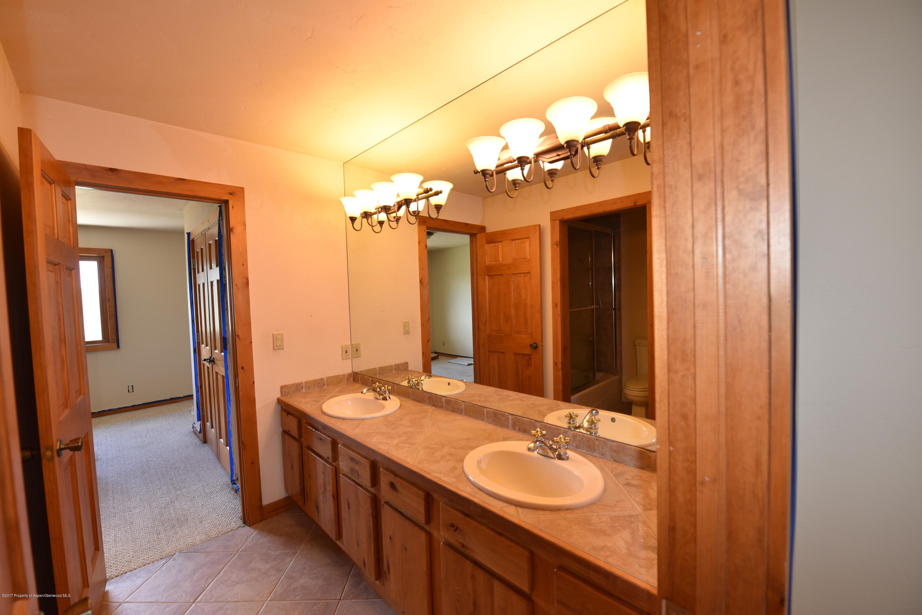 3744 County Road 237 Rifle, CO 81650 - Photo 19 of 37 a bathroom with a double vanity sink and a mirror