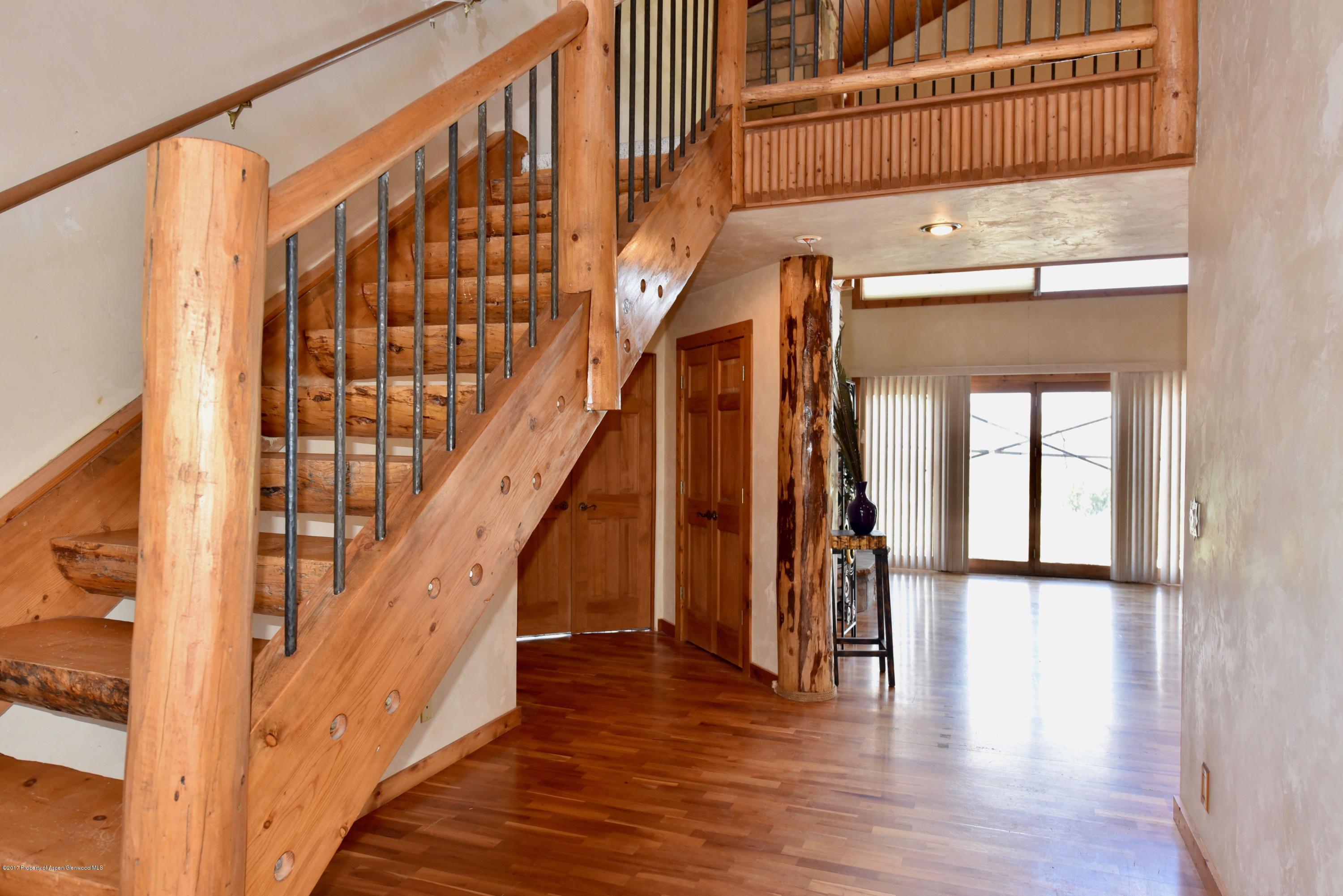 3744 County Road 237 Rifle, CO 81650 - Photo 26 of 37 a view of staircase with wooden floor and a large window