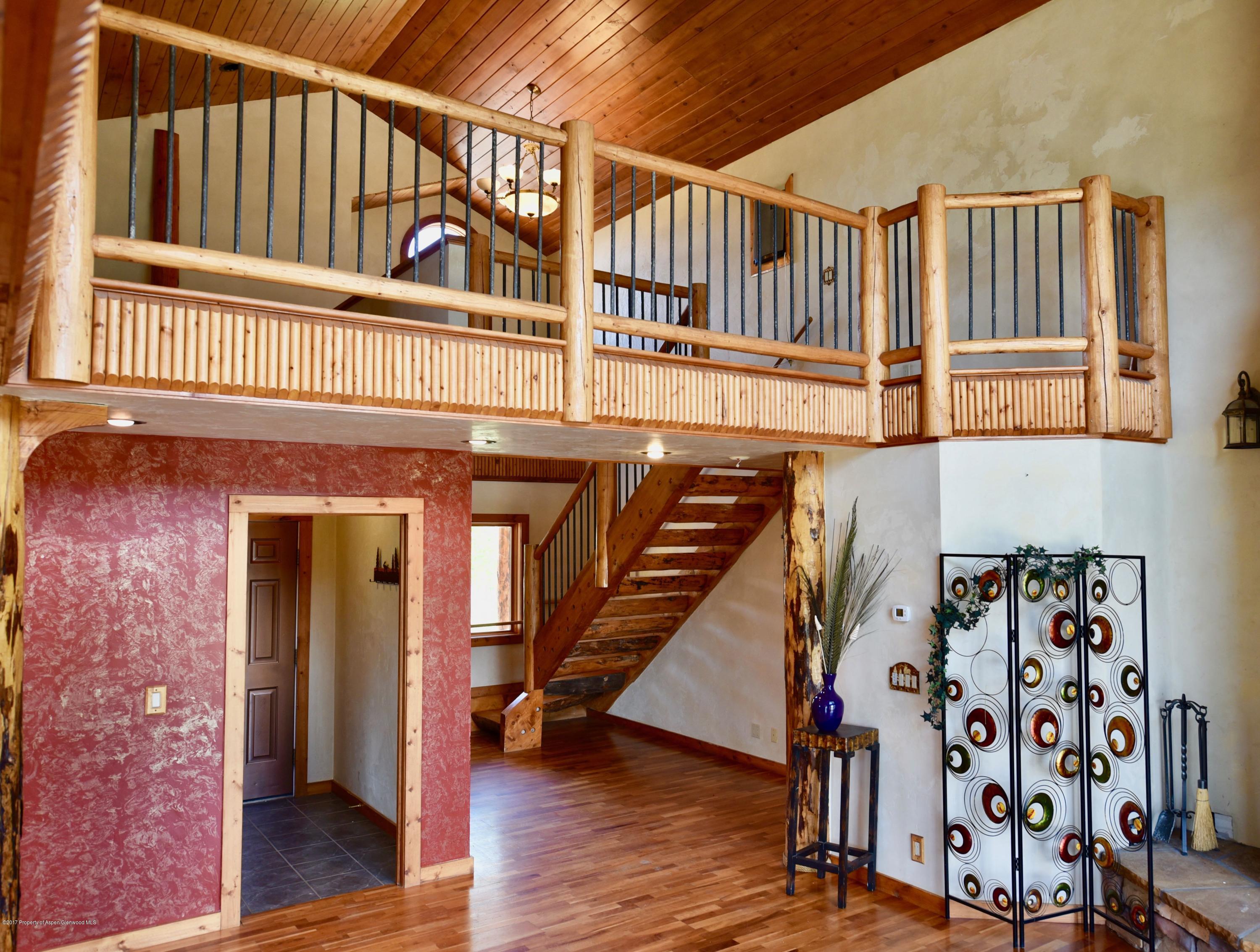 3744 County Road 237 Rifle, CO 81650 - Photo 27 of 37 a view of entryway with wooden floor and stairs