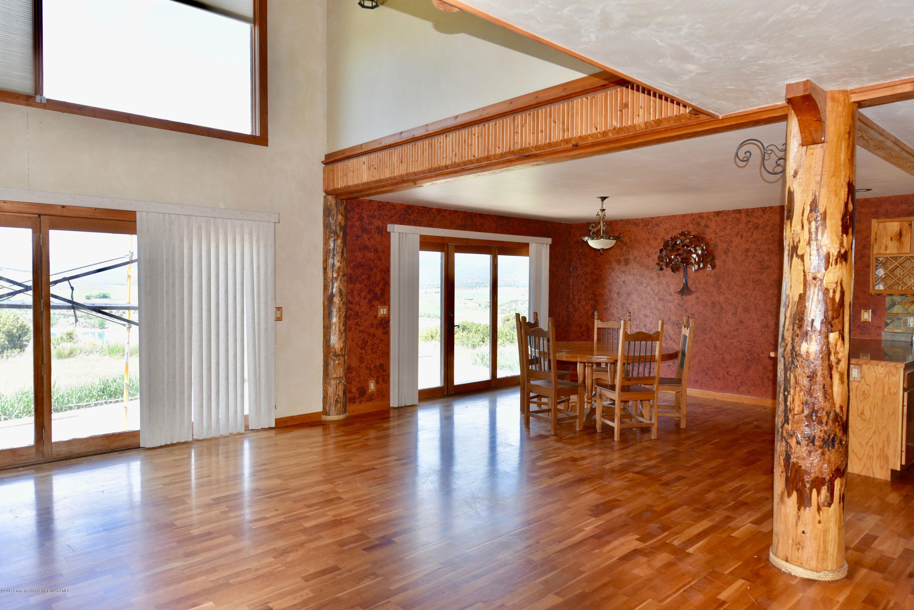 3744 County Road 237 Rifle, CO 81650 - Photo 30 of 37 a view of a dining room with furniture and wooden floor