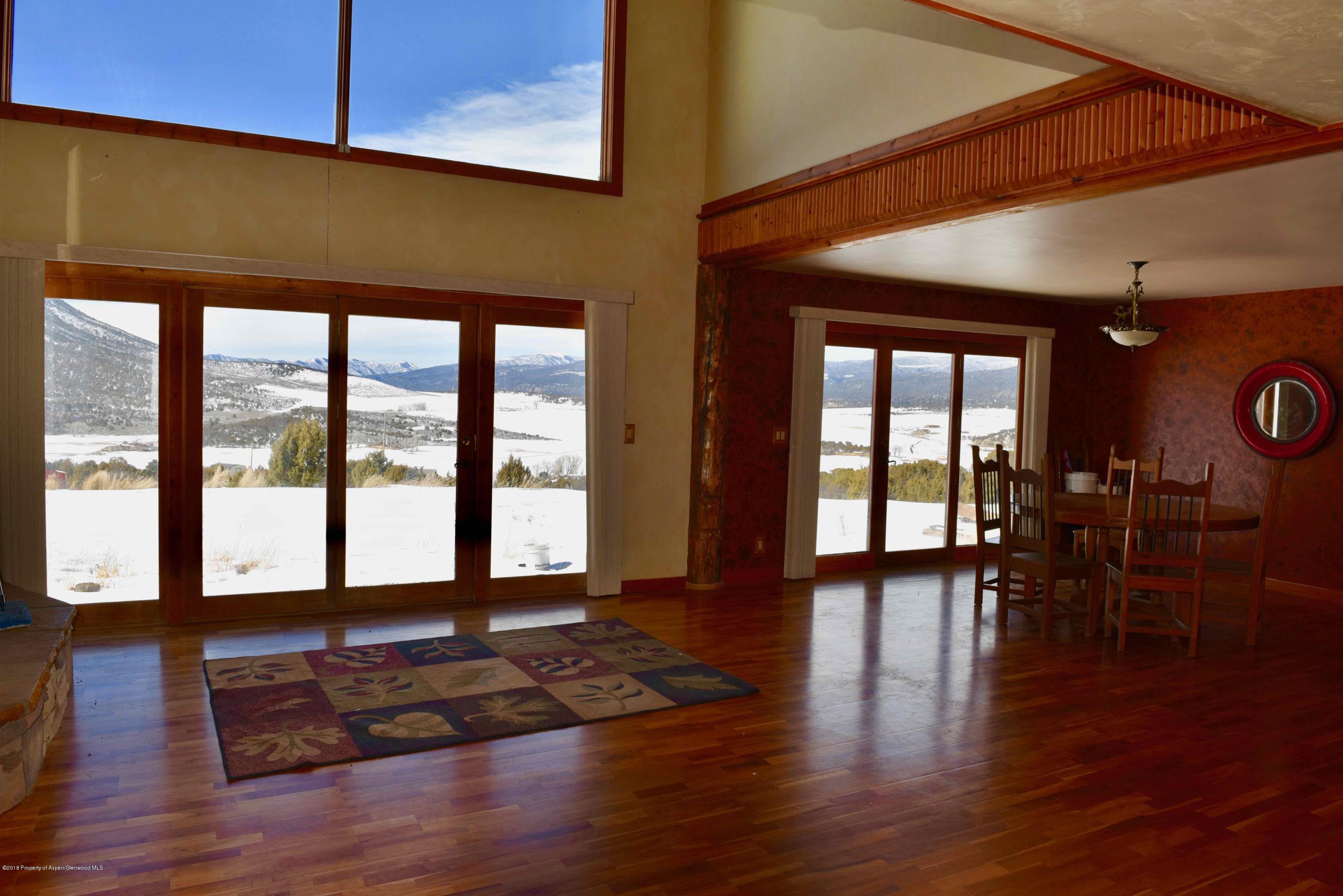3744 County Road 237 Rifle, CO 81650 - Photo 10 of 37 a living room with hardwood floor and a large window