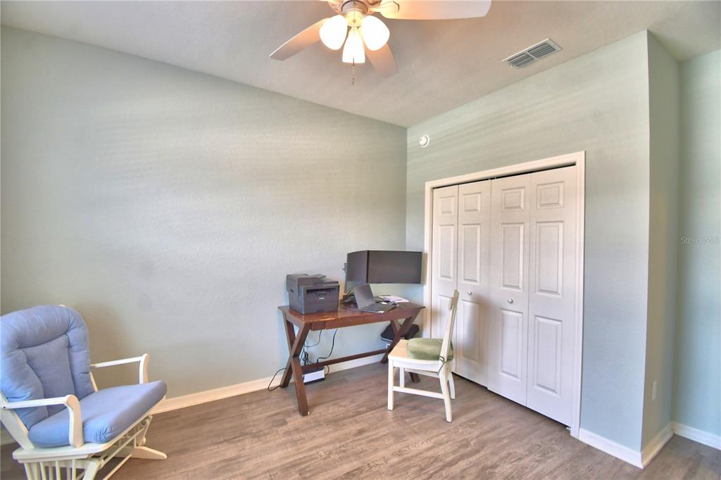 4340 Reding Way Lakeland, FL 33813 - Photo 21 of 63 a workspace with wooden floor and a chair