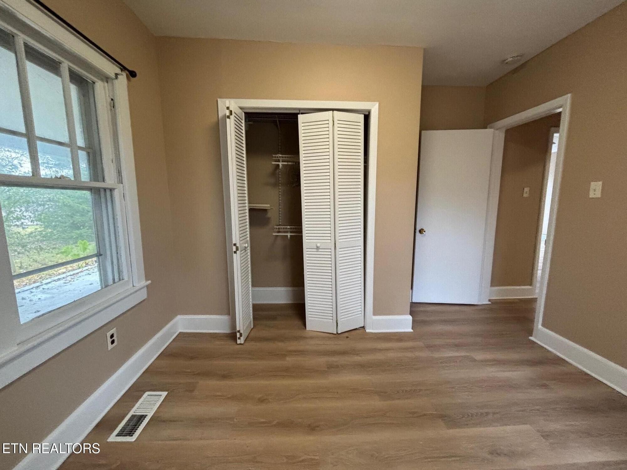 7005 Washington Pike, Unit A Corryton, TN 37721 - Photo 11 of 17 an empty room with windows and closet