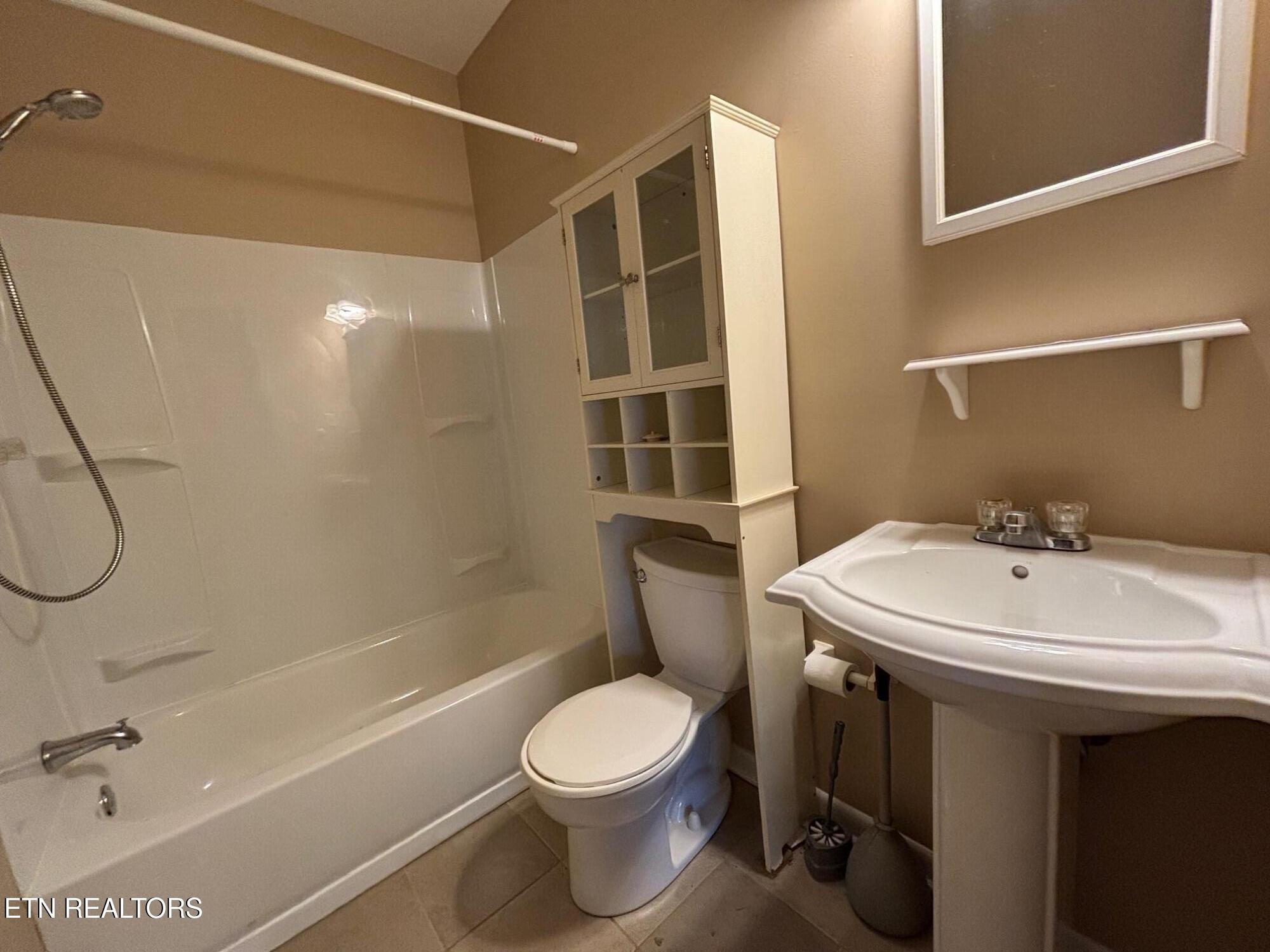 7005 Washington Pike, Unit A Corryton, TN 37721 - Photo 13 of 17 a bathroom with a sink a toilet and shower