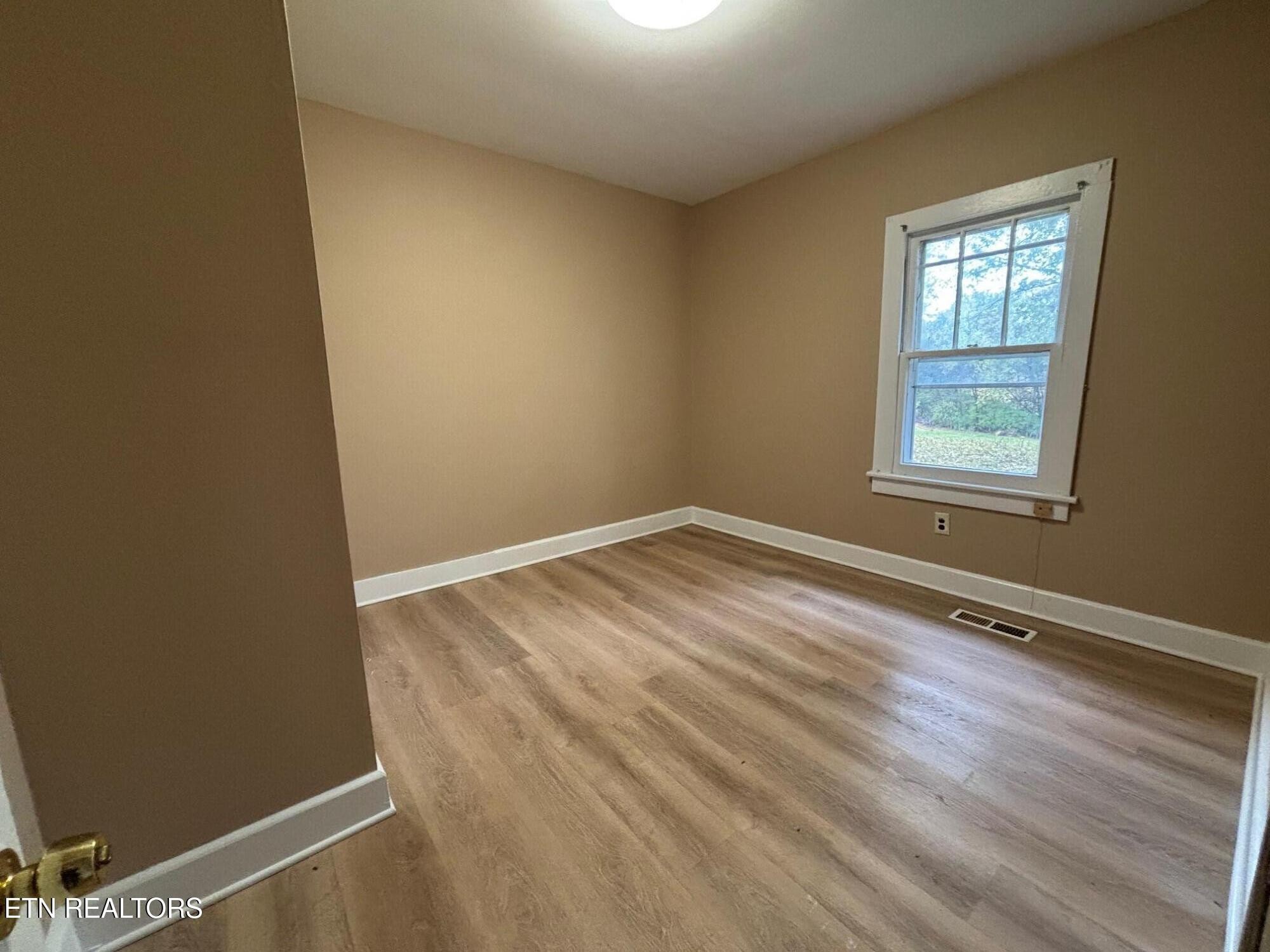 7005 Washington Pike, Unit A Corryton, TN 37721 - Photo 14 of 17 an empty room with a window