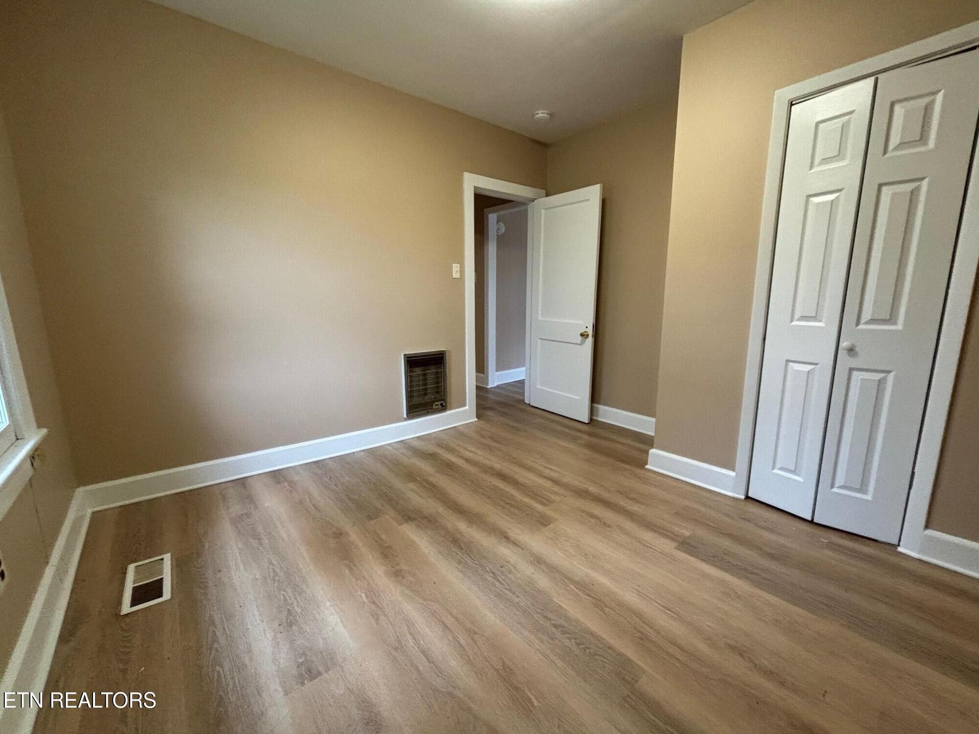 7005 Washington Pike, Unit A Corryton, TN 37721 - Photo 15 of 17 a view of an empty room and wooden floor