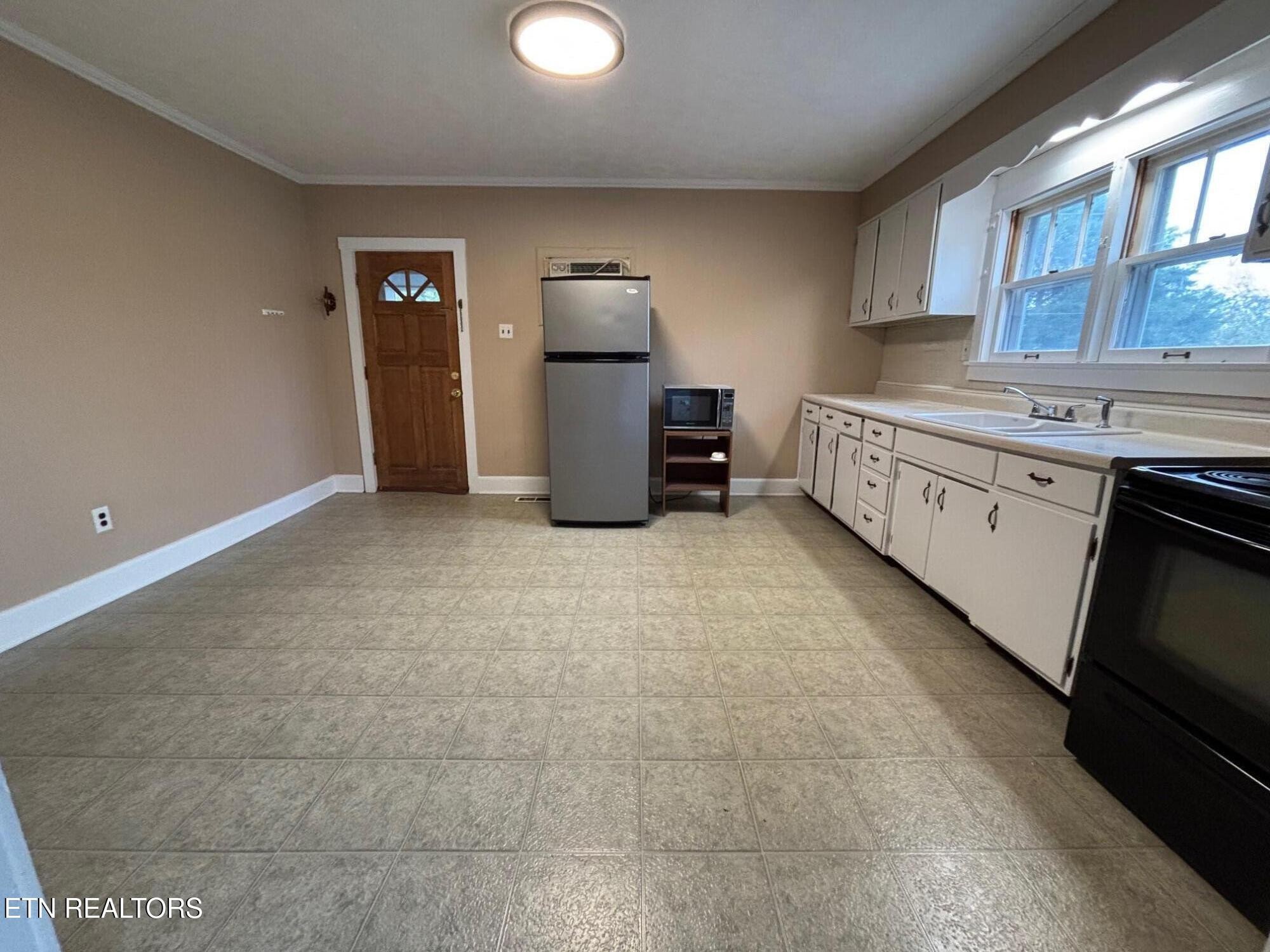 7005 Washington Pike, Unit A Corryton, TN 37721 - Photo 6 of 17 a kitchen with granite countertop a refrigerator and a stove