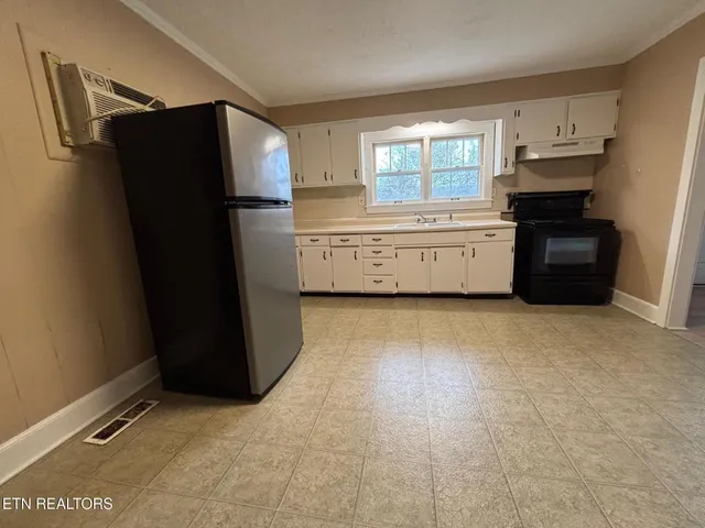 a kitchen with refrigerator and window