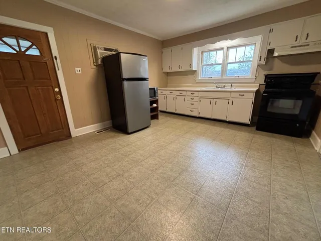 a big room with closet and a window
