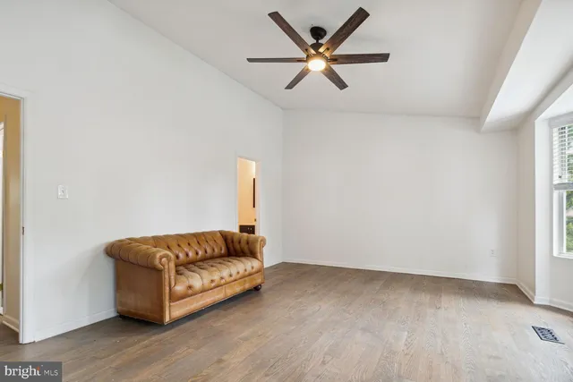a living room with a couch and a window