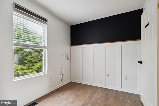 a view of an empty room with a flat screen tv and a window